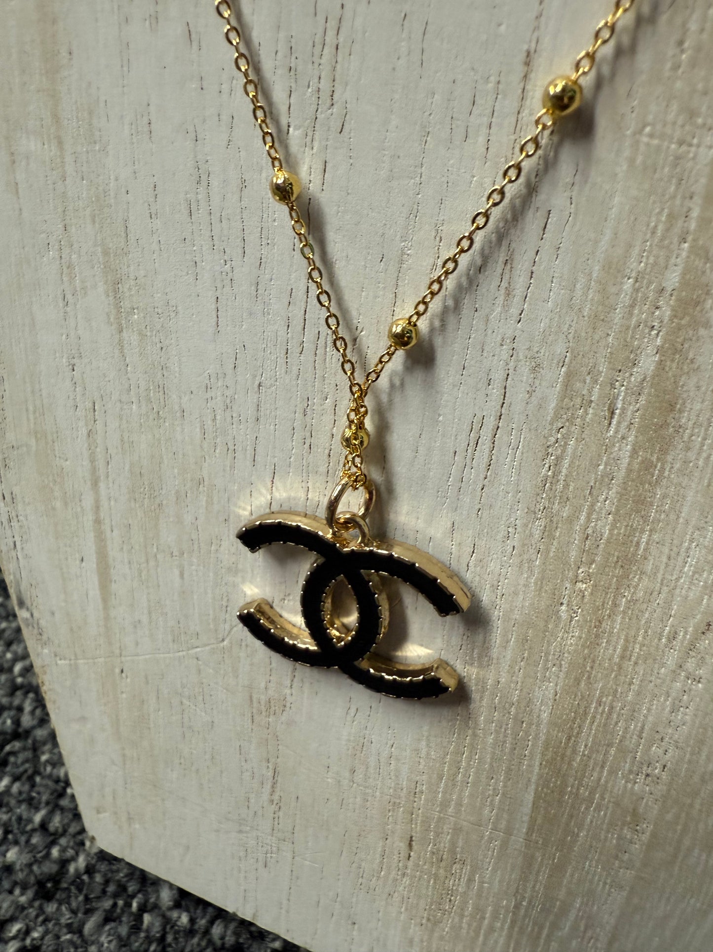Gold Tone Necklace with Black Accent Pendant